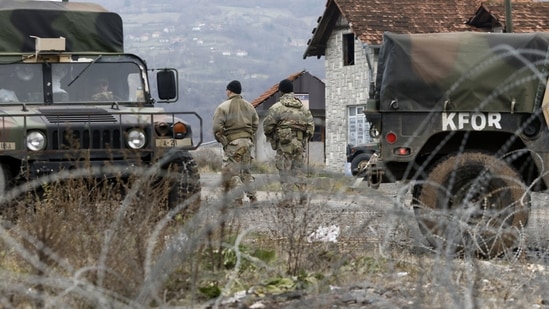 US soldiers serving in NATO-led peacekeeping force KFOR, guard a checkpoint on the road near the northern Kosovo border crossing of Jarinje, along the Kosovo-Serbia border, Kosovo.(AP)