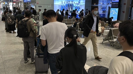 Passengers prepare to board a flight at the airport in north-central China's Jiangxi province. (AP Photo/Ng Han Guan)