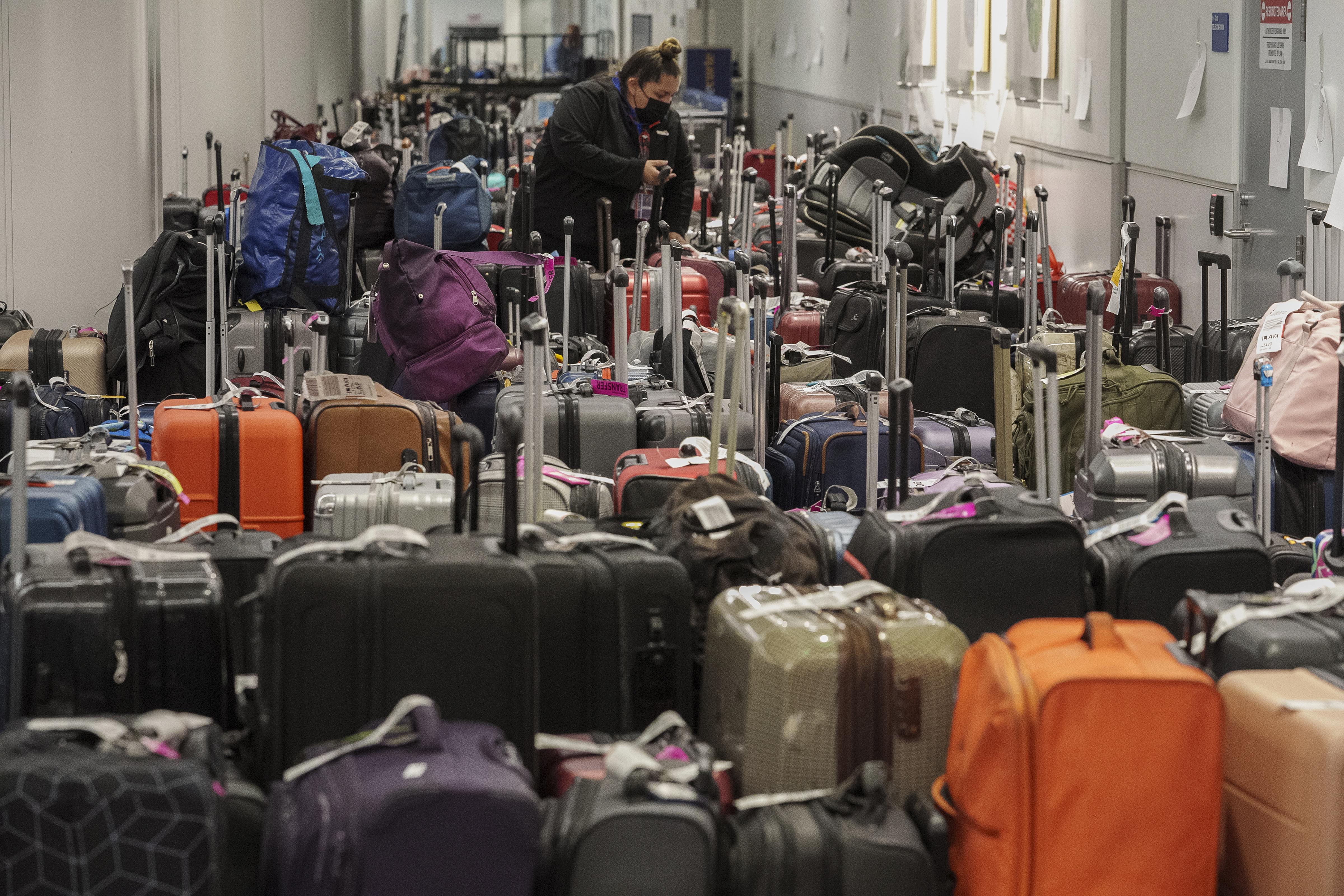 Southwest Airlines staff sorts suitcases near the baggage carousel at Los Angeles International Airport Tuesday, Dec. 27, 2022, after Southwest Airlines flights were canceled and delayed during a winter storm. AP/PTI Southwest Airlines staff sorts suitcases near the baggage carousel at Los Angeles International Airport Tuesday, Dec. 27, 2022, after Southwest Airlines flights were canceled and delayed during a winter storm. AP/PTI