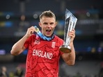 England's Sam Curran celebrates winning the T20 World Cup with the trophy.