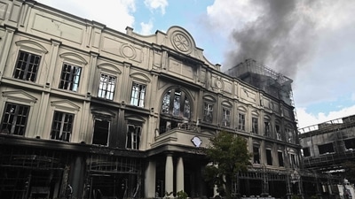 Smoke rises from part of the Grand Diamond City hotel-casino as firefighters worked to extinguish a major fire at the complex in Poipet. (AFP)