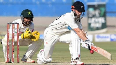 New Zealand's Kane Williamson (R) plays a shot during the fourth day of the first Test match between Pakistan and New Zealand at the National Stadium in Karachi on December 29, 2022. (Photo by Asif HASSAN / AFP) (AFP)
