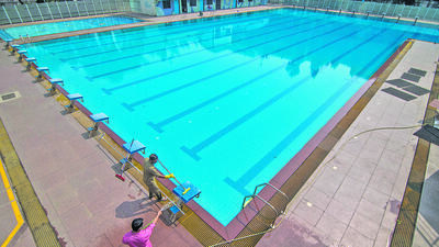 Mumbai, India - November 05, 2020: Workers are seen cleaning up the swimming pool to make it ready to reopen after government has given permission to reopen the swimming pool after being shut for nearly 6-7 months due to Covid-19 pandemic at A.K. Vaidya Swimming Pool, Chembur in Mumbai, India, on Thursday, November 5, 2020. (Photo by Pratik Chorge/Hindustan Times) (Pratik Chorge/HT PHOTO) Mumbai, India - November 05, 2020: Workers are seen cleaning up the swimming pool to make it ready to reopen after government has given permission to reopen the swimming pool after being shut for nearly 6-7 months due to Covid-19 pandemic at A.K. Vaidya Swimming Pool, Chembur in Mumbai, India, on Thursday, November 5, 2020. (Photo by Pratik Chorge/Hindustan Times) (Pratik Chorge/HT PHOTO)