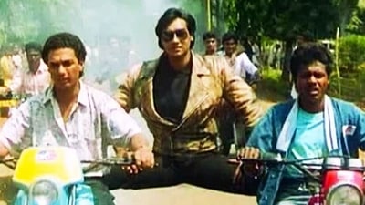 Ajay Devgn doing the iconic split on two bikes in his Bollywood debut film Phool Aur Kaante. Ajay Devgn doing the iconic split on two bikes in his Bollywood debut film Phool Aur Kaante.