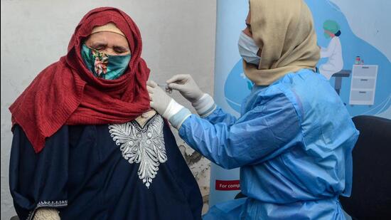 A healthcare worker administers a booster dose of Covid vaccine to a woman during a special drive in Srinagar. (PTI)