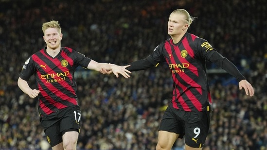 Manchester City's Erling Haaland, right, celebrates with teammate Kevin De Bruyne (AP)