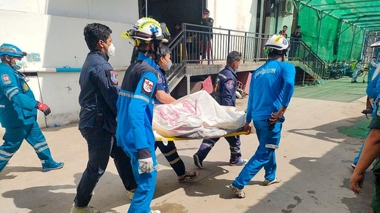 Many of the people inside the hotel, both customers and staff, were from the neighbouring country Thailand. In this picture, rescue workers can be seen carrying a victim on a stretcher after a fire at the Grand Diamond City hotel-casino in Poipet.(AFP)