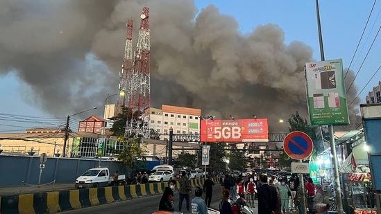 In a video shared by Cambodia's firefighting agency on social media, onlookers could be heard shouting pleas to rescue people trapped on the roof of the hotel complex, which is more than a dozen stories tall at its highest point. The video showed at least one man falling as the flames reached the roof. (AFP)