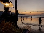 Covid In Indonesia: People enjoy the beach during sunset in Jimbaran, Bali.