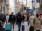 Covid In Spain: Tourists wheel luggage along the Gran Via in central Madrid, Spain. Covid In Spain: Tourists wheel luggage along the Gran Via in central Madrid, Spain.