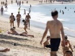People walk at Kamala beach in Phuket, Thailand. Thailand gears up for return of Chinese tourists with caution as Covid-19 surges 