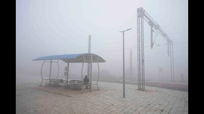 A passenger waits for a train on a cold and foggy morning in Lucknow on Friday. (Agency)