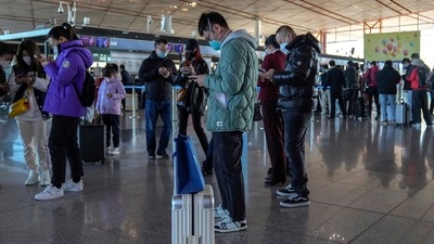 Covid Curbs On China Visitors: Masked travellers use their smartphones to fill in their health declaration. (AP)