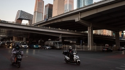 Covid In China: Motorists and vehicles travel along a road in the Central Business District.in Beijing. (Bloomberg) Covid In China: Motorists and vehicles travel along a road in the Central Business District.in Beijing. (Bloomberg)