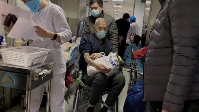 Covid In China: A Covid-19 patient being moved on a wheelchair at Tianjin First Center Hospital in Tianjin. (AFP) Covid In China: A Covid-19 patient being moved on a wheelchair at Tianjin First Center Hospital in Tianjin. (AFP)