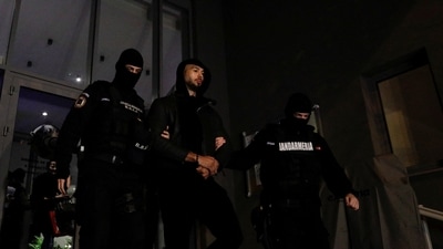 Andrew Tate Arrested In Romania: Andrew Tate escorted by police officers. (Reuters)