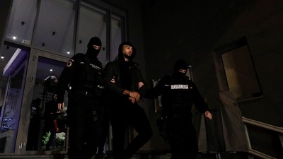 Andrew Tate escorted by police officers. (Reuters)