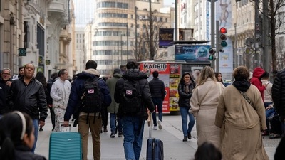 Covid In Spain: Tourists wheel luggage along the Gran Via in central Madrid, Spain. (Bloomberg)