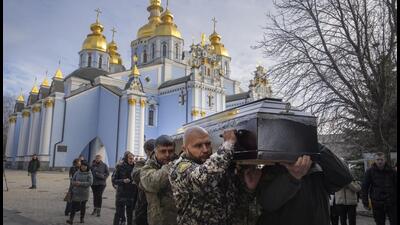 Soldiers and friends carry a coffin of Gennadiy Afanasyev, Ukrainian army volunteer and former political prisoner of the Kremlin, killed in a battlefield with Russian forces at the frontline in Luhansk region, during his funeral ceremony in St. Michael Cathedral in Kyiv, Ukraine, on Friday. (AP) Soldiers and friends carry a coffin of Gennadiy Afanasyev, Ukrainian army volunteer and former political prisoner of the Kremlin, killed in a battlefield with Russian forces at the frontline in Luhansk region, during his funeral ceremony in St. Michael Cathedral in Kyiv, Ukraine, on Friday. (AP)
