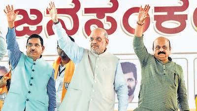 Union Ministers and senior BJP leaders Amit Shah and Pralhad Joshi (L) with Karnataka Chief Minister Basavaraj Bommai (R) at Bharatiya Janata Party's Jan Sankalp Yatra rally. (PTI) Union Ministers and senior BJP leaders Amit Shah and Pralhad Joshi (L) with Karnataka Chief Minister Basavaraj Bommai (R) at Bharatiya Janata Party's Jan Sankalp Yatra rally. (PTI)