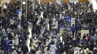 Covid In Japan: Travelers crowd at a departure lobby of Haneda airport in Tokyo. (AP) Covid In Japan: Travelers crowd at a departure lobby of Haneda airport in Tokyo. (AP)