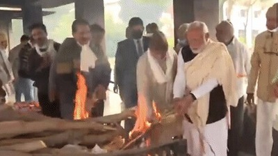 Prime Minister Narendra Modi lights the pyre of his mother Heeraben Modi. (ANI)