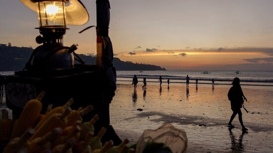 Covid In Indonesia: People enjoy the beach during sunset in Jimbaran, Bali.(Reuters)