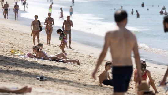 People walk at Kamala beach in Phuket, Thailand. Thailand gears up for return of Chinese tourists with caution as Covid-19 surges (REUTERS/Jorge Silva)