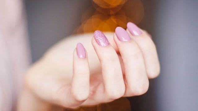 Add some sparkle to your nails with a glittery nail polish(Pexels)