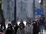 People wearing face masks walk on a street, as coronavirus disease (COVID-19) outbreaks continue in Shanghai, China.