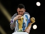 Argentina's Lionel Messi kisses the World Cup trophy after receiving the Golden Ball award as he celebrates after winning the World Cup.(Reuters)