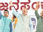 Union Minister Amit Shah with Pralhad Joshi (L) and Karnataka Chief Minister Basavaraj Bommai (R) on Saturday. (PTI) Union Minister Amit Shah with Pralhad Joshi (L) and Karnataka Chief Minister Basavaraj Bommai (R) on Saturday. (PTI)
