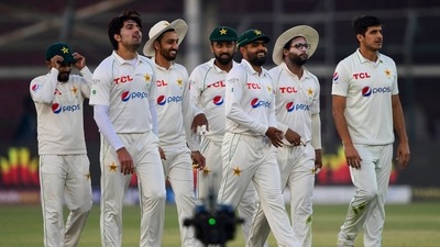 Pakistan's cricketers walk back to the pavilion at the end of the fifth and final day of the first Test match between Pakistan and New Zealand at the National Stadium in Karachi on December 30, 2022. (Photo by Asif HASSAN / AFP) (AFP)