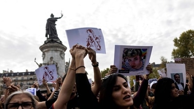 Protestors hold portraits of Mahsa Amini and Iranian who were arrested or killed in the recent uprising in Iran during a rally in solidarity with Iranian protestors, at the Place de la Republique in Paris, on October 29. (AFP) Protestors hold portraits of Mahsa Amini and Iranian who were arrested or killed in the recent uprising in Iran during a rally in solidarity with Iranian protestors, at the Place de la Republique in Paris, on October 29. (AFP)