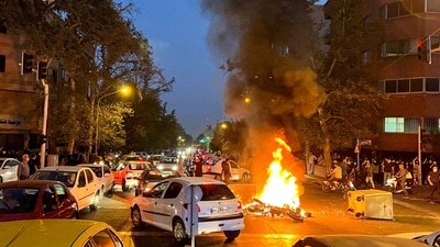 Iran Anti-Hijab Protests: A police motorcycle burns during a protest. (Reuters)