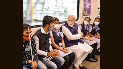Prime Minister Narendra Modi interacts with students during a metro ride from Garware College to Anandnagar Metro station after inaugurating the metro rail in Pune on March 6, 2022. (HT PHOTO)