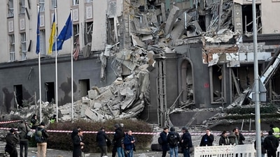 People gather at the bottom of a hotel, which has been partially destroyed by a Russian strike in the center of the Ukrainian capital, Kyiv on December 31. (AFP) People gather at the bottom of a hotel, which has been partially destroyed by a Russian strike in the center of the Ukrainian capital, Kyiv on December 31. (AFP)