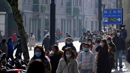 People wearing face masks walk on a street, as coronavirus disease (COVID-19) outbreaks continue in Shanghai, China.(REUTERS file)