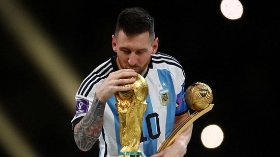 Argentina's Lionel Messi kisses the World Cup trophy after receiving the Golden Ball award as he celebrates after winning the World Cup.(Reuters)