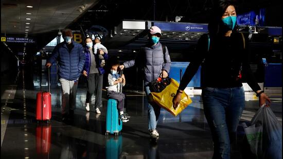 Travellers walk with their luggage at Beijing Capital International Airport, amid the coronavirus disease (COVID-19) outbreak in Beijing, China December 27, 2022. REUTERS/Tingshu Wang (REUTERS)