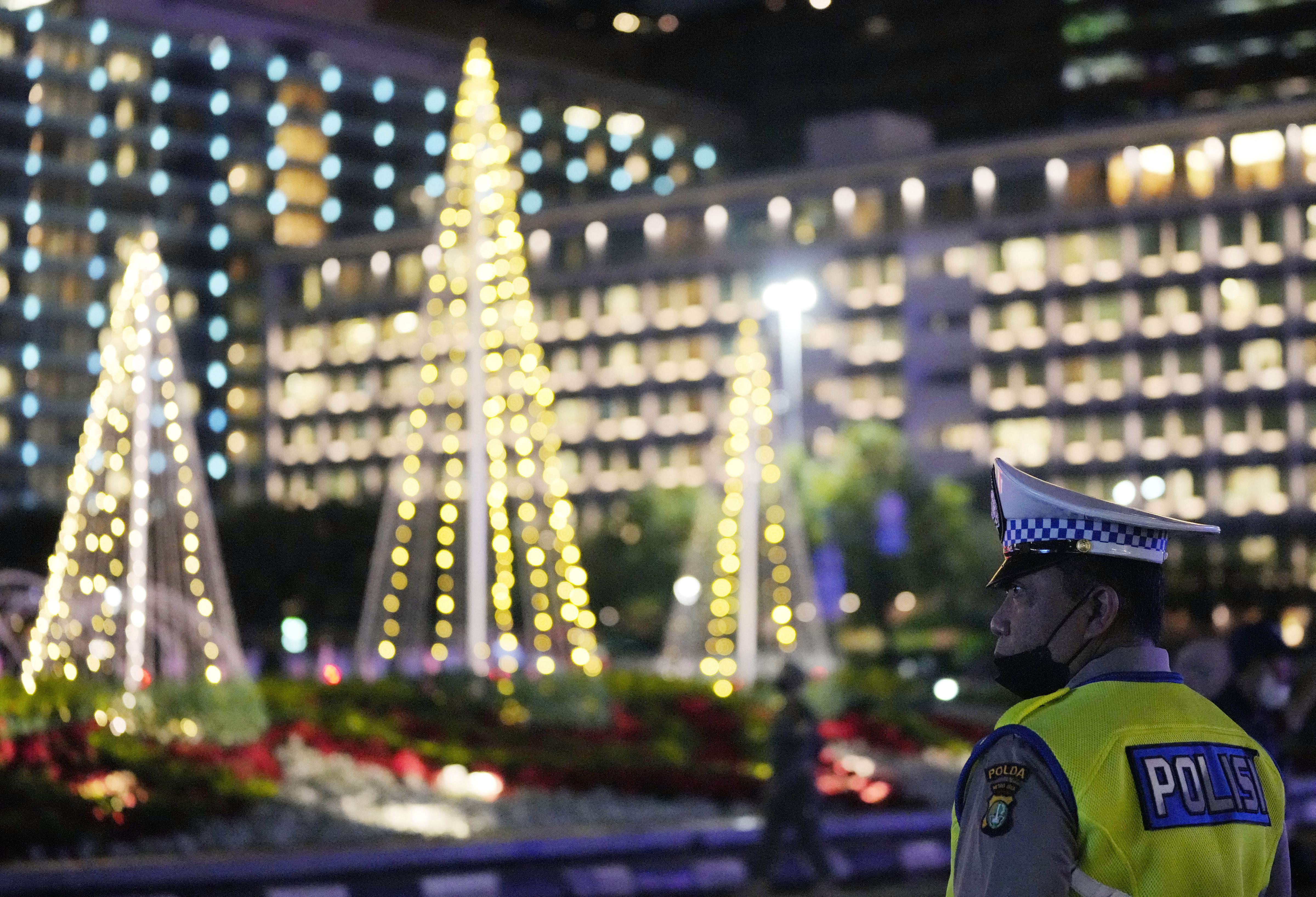 Indonesian police officers stand guard in the main business district on New Year's Eve in Jakarta, Indonesia. (AP)