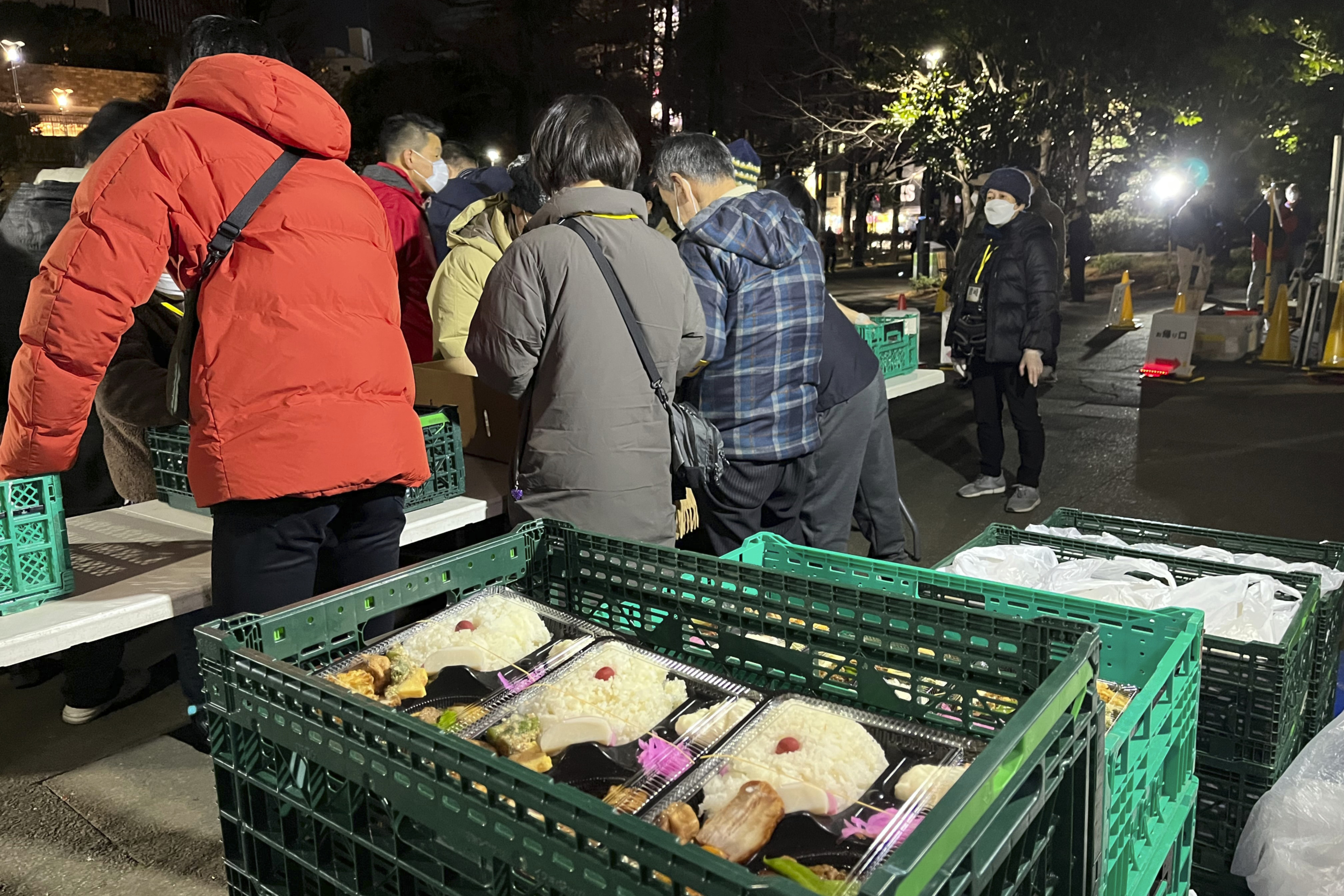 Volunteers hand out free meals for the homeless at a Tokyo park. (AP)