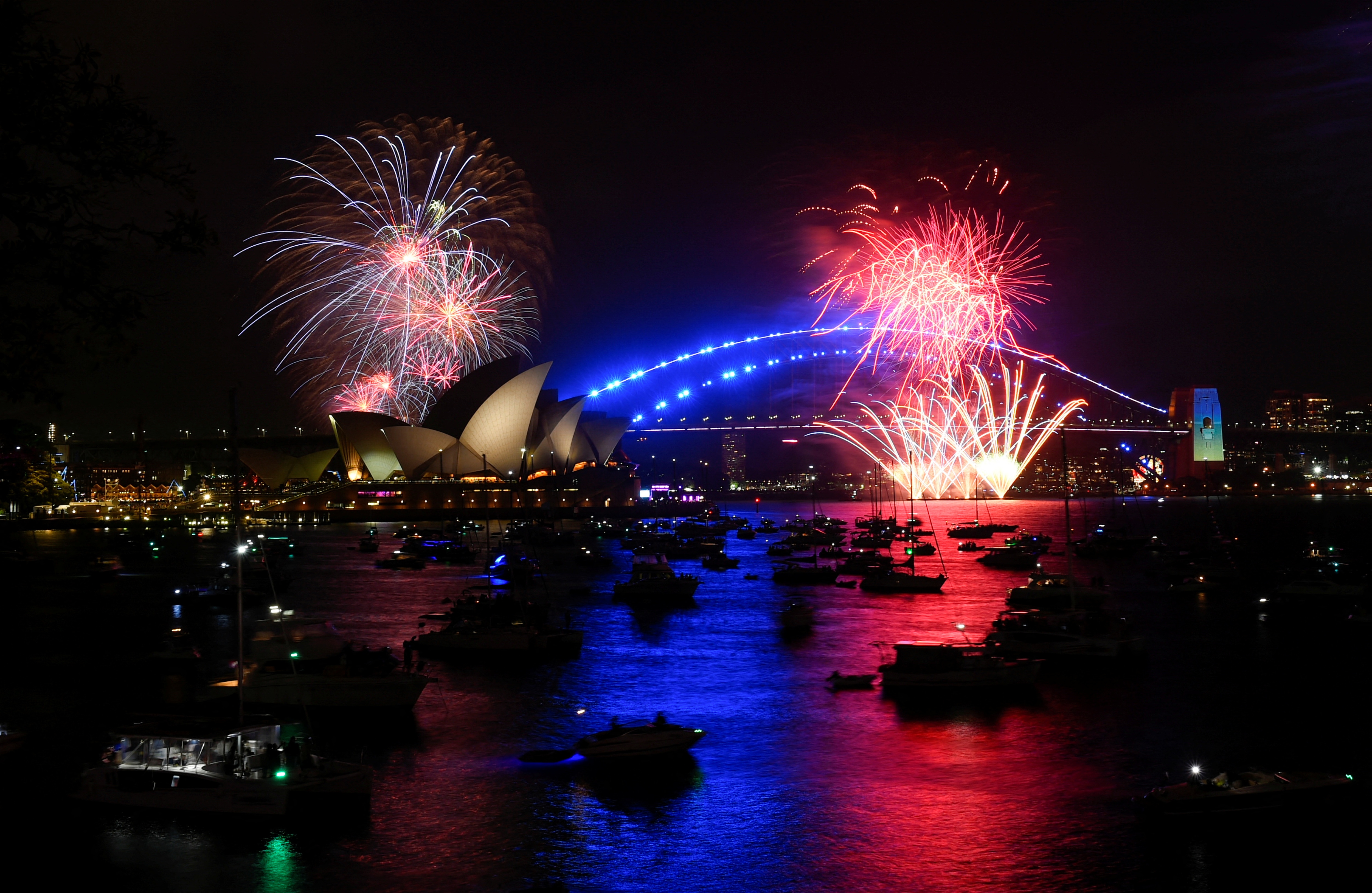 Early fireworks explode over Sydney Opera House during the New Year's Eve celebrations, in Sydney, Australia. (Reuters)