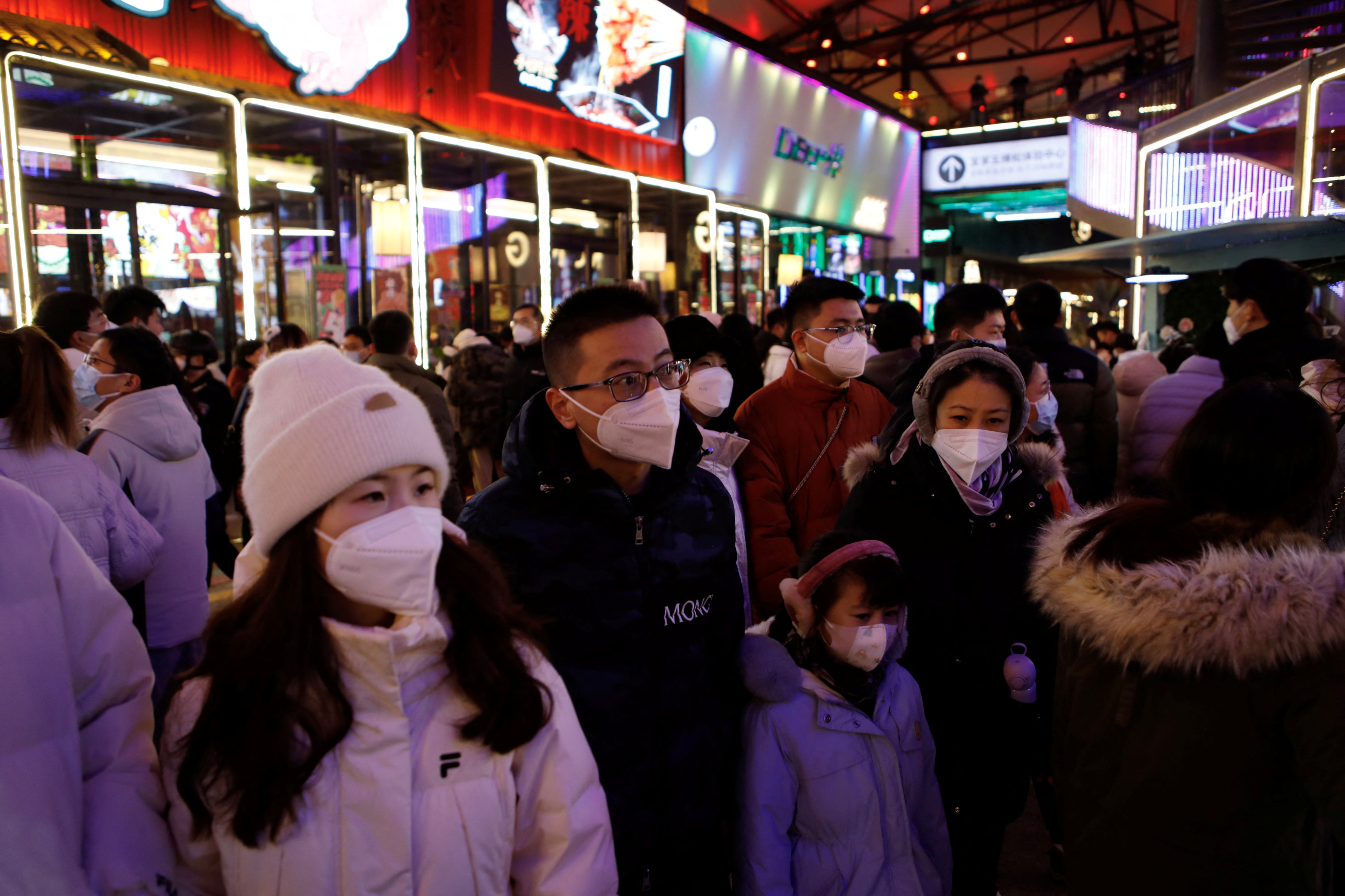 Visitors throng a shopping complex on New Year's Eve. (Reuters)