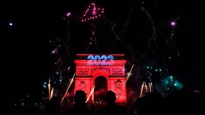 Fireworks explode next to the Arc de Triomphe, at the Avenue des Champs-Elysees during New Year celebrations in Paris, early on January 1, 2023. (AFP)