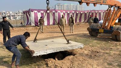 The open manhole being covered with a cement slab on Derabassi DSP’s directions. (HT File) The open manhole being covered with a cement slab on Derabassi DSP’s directions. (HT File)