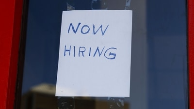 A "Now Hiring" sign is displayed on a storefront. (AFP file)