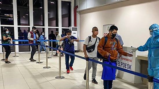 Passengers undergo thermal screening as random Covid-19 testing starts at various airports across the country in the wake of rising cases of Coronavirus globally.