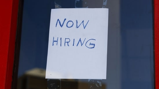 A "Now Hiring" sign is displayed on a storefront.(AFP file)