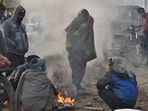 People warm themselves around a bonfire on a cold winter morning at Ghazipur market in New Delhi (Raj K Raj / HT Photo) People warm themselves around a bonfire on a cold winter morning at Ghazipur market in New Delhi (Raj K Raj / HT Photo)
